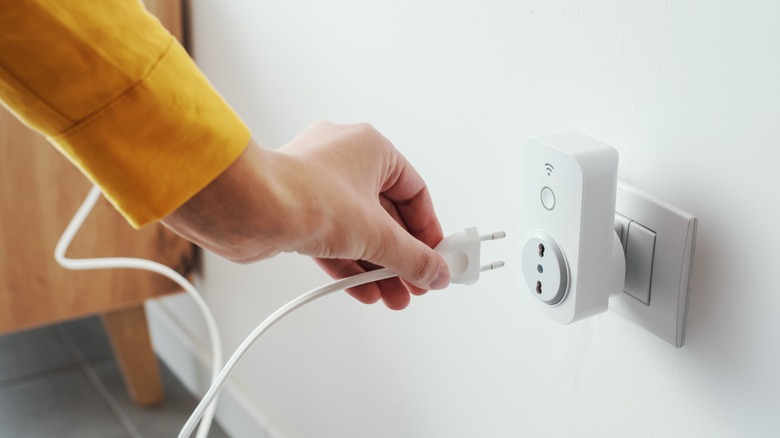 plugging cord into smart plug