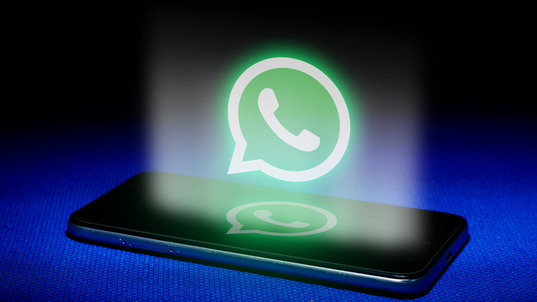 A smartphone and the WhatsApp Messenger logo