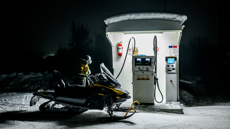 Snowmobile being refueled