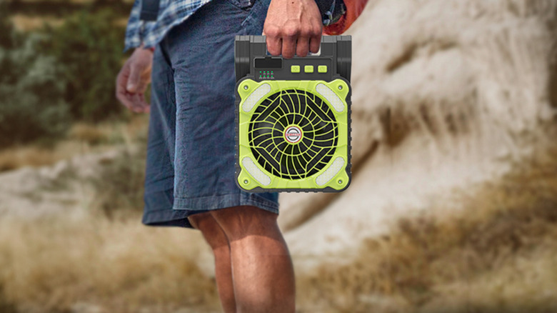 Man carrying a solar fan