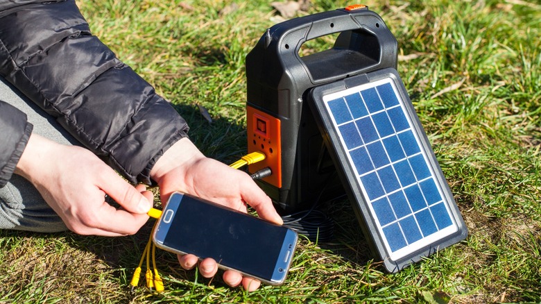 Small solar power supply being charged by solar panel