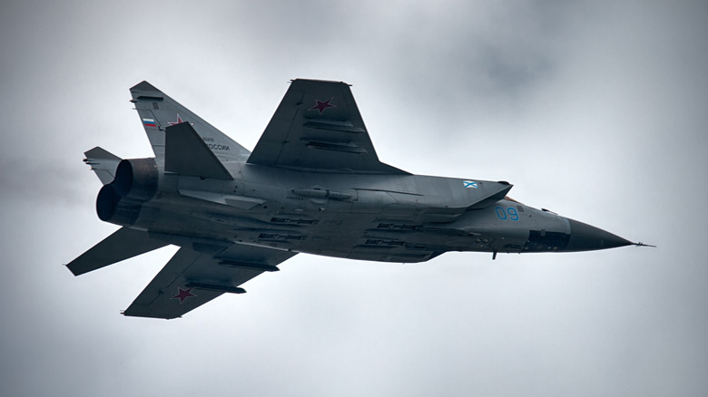 MiG-25 Foxbat flying among clouds