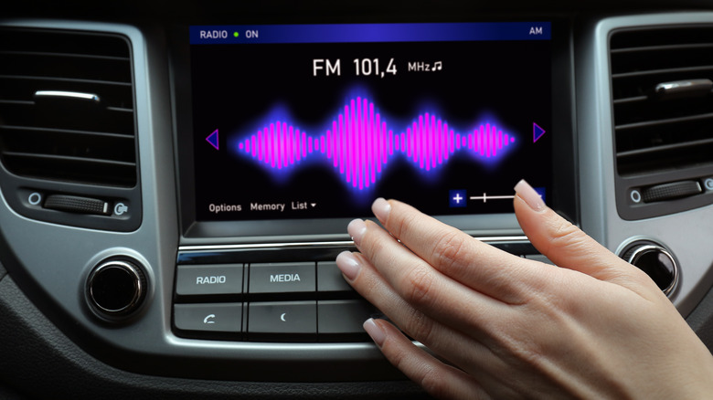 Woman using car stereo