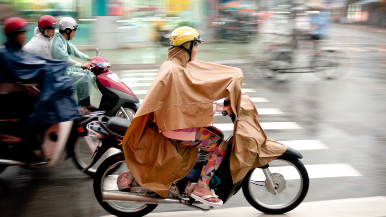 Riding on motorcycle with poncho on