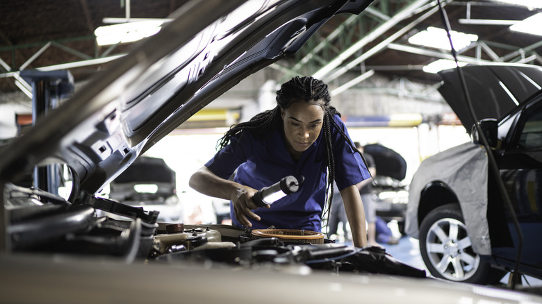 Mechanic inspecting engine