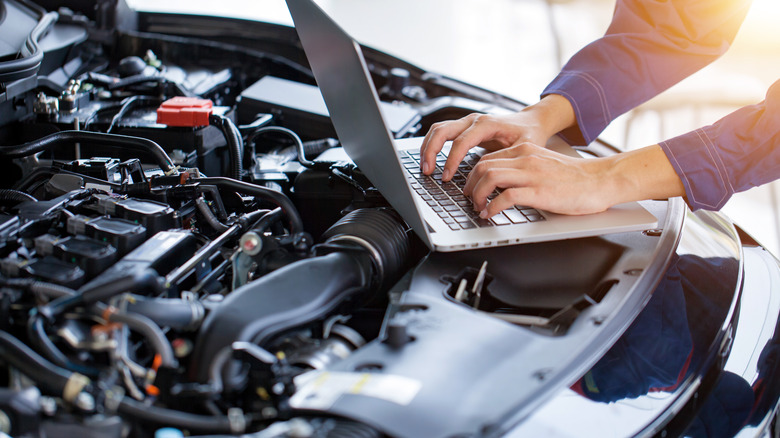 Laptop next to car engine