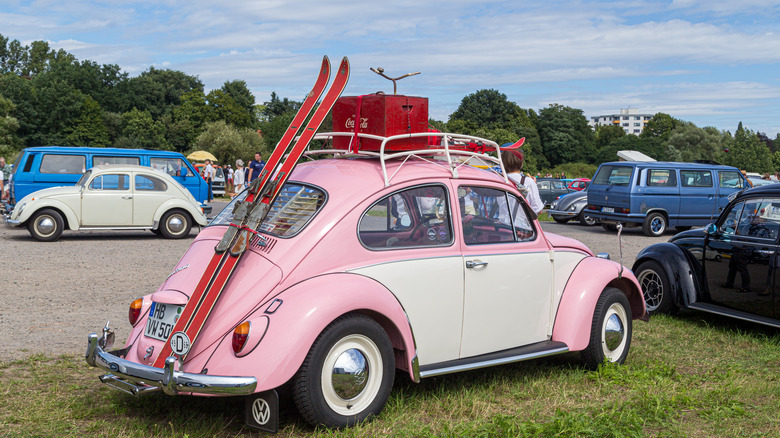 pink VW beetle at outdoor gathering