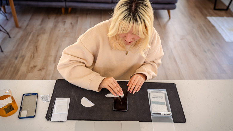 Woman replacing iPhone screen