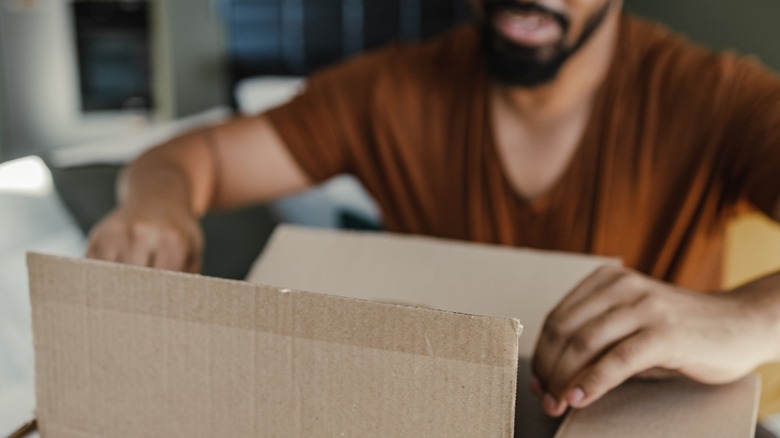 Man opening cardboard box