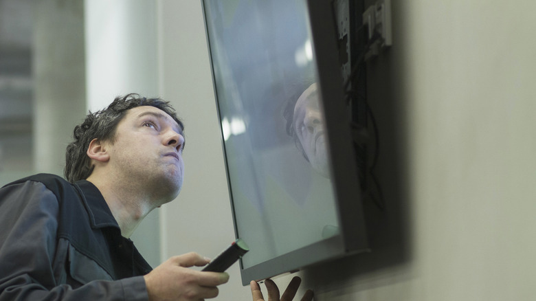 Man looking at TV screen