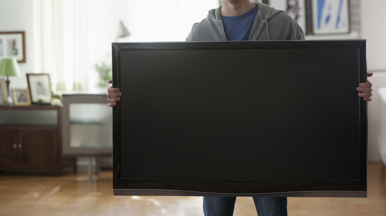 Man holding a TV