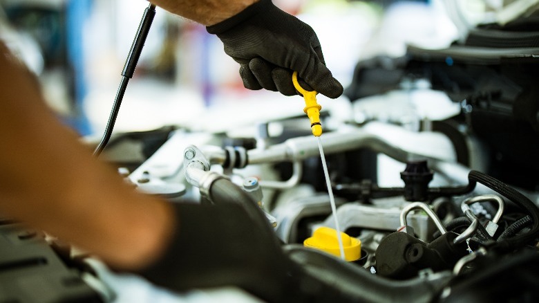 Lifting a car's engine oil dipstick