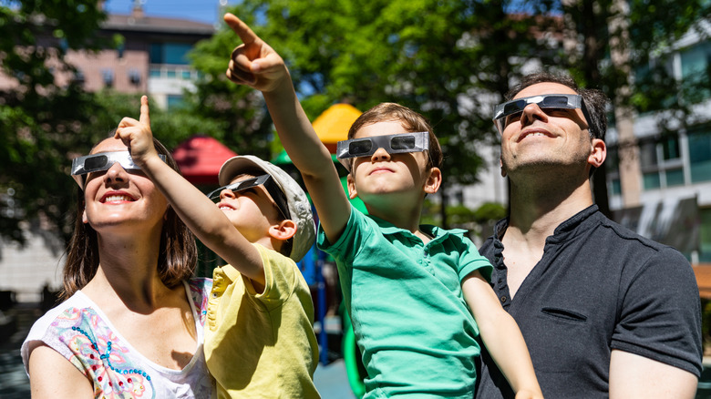 A family viewing a solar eclipse