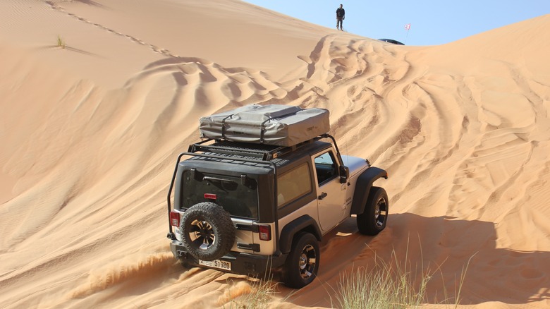 SUV with packed rooftop tent