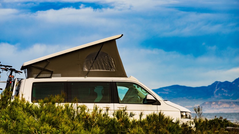 Van with hard shell rooftop tent