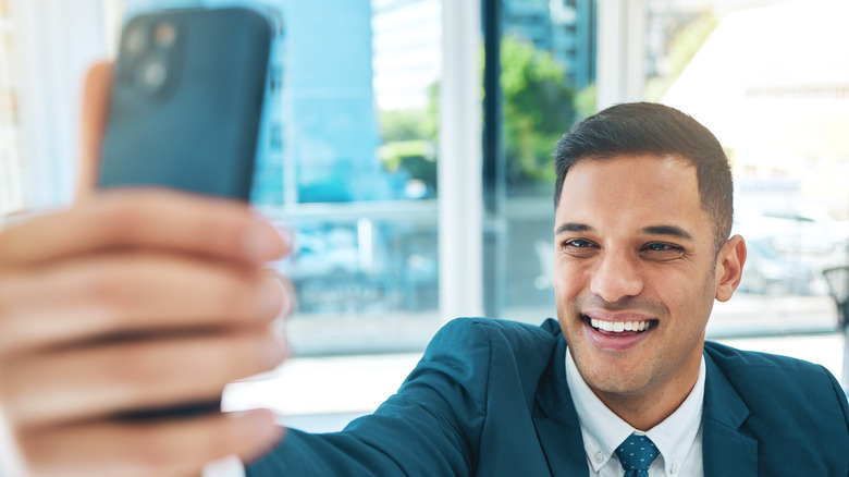 smiling man taking a selfie