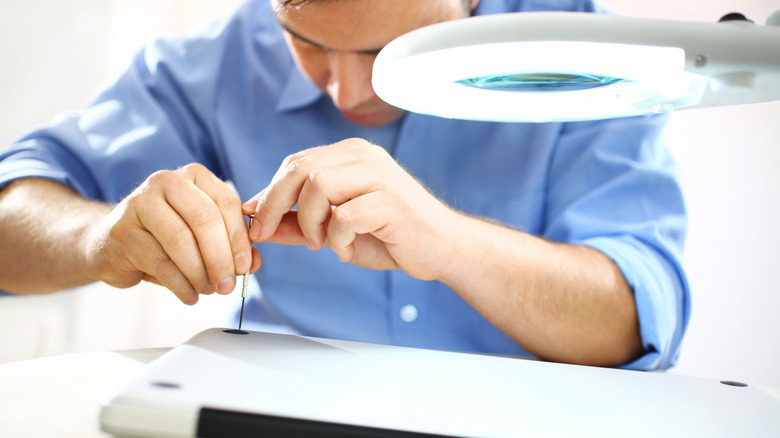 laptop repair man using screwdriver