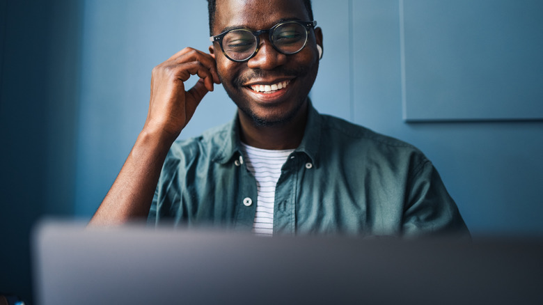 man happy watching laptop