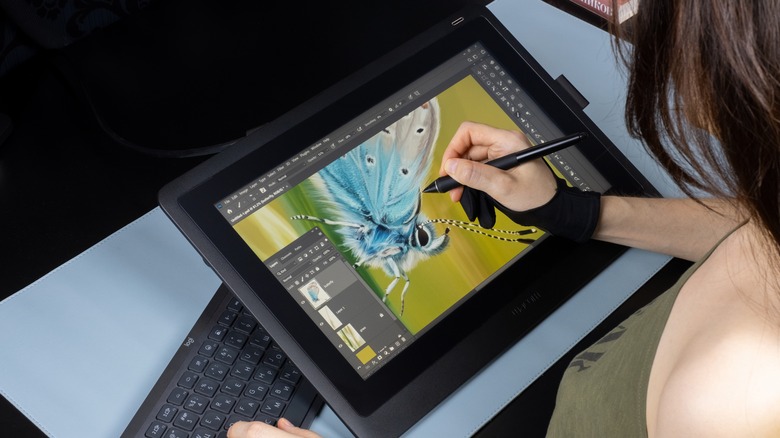 Artist illustrating on tablet Photoshop