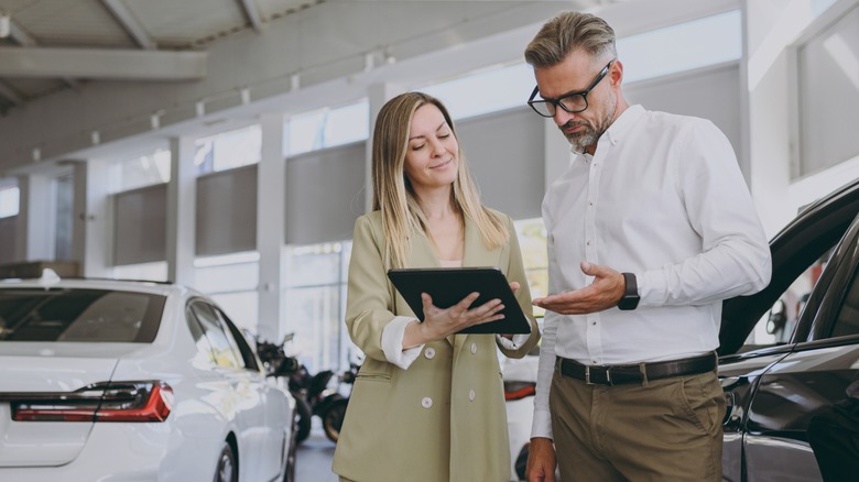 Manager and customer talking at a dealership