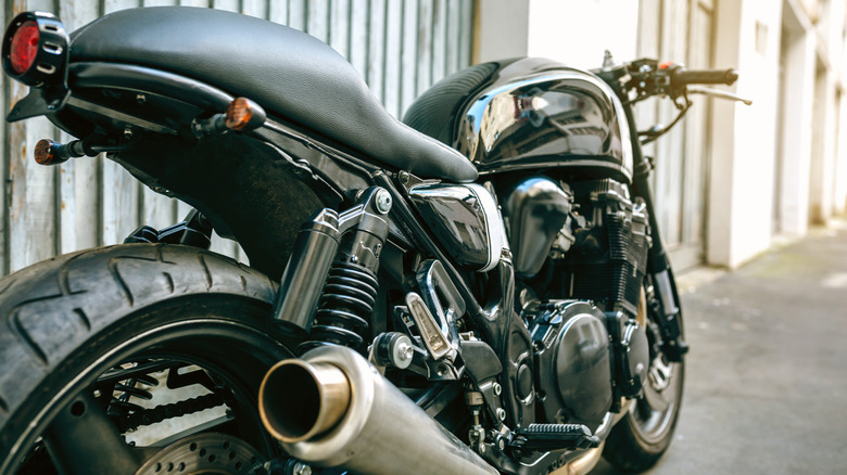 Customized motorcycle in front of a garage