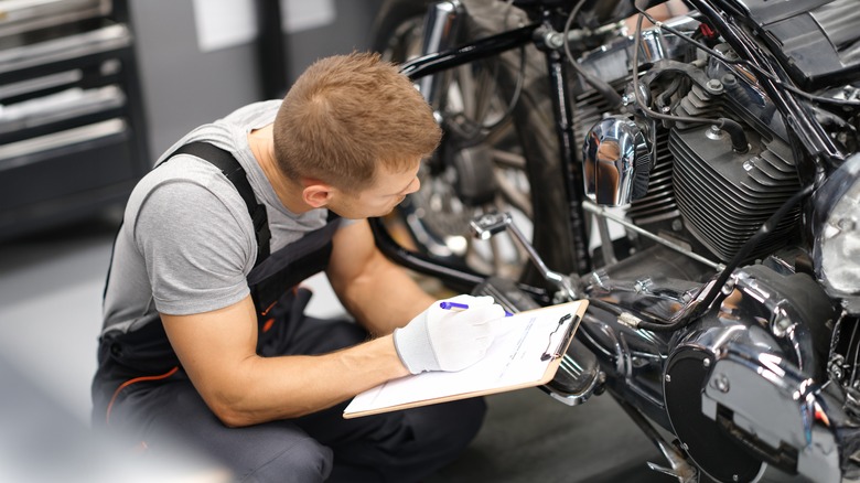 Worker inspects motorcycle