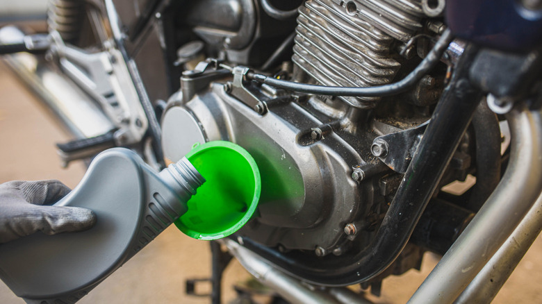 Pouring oil into a motorcycle engine