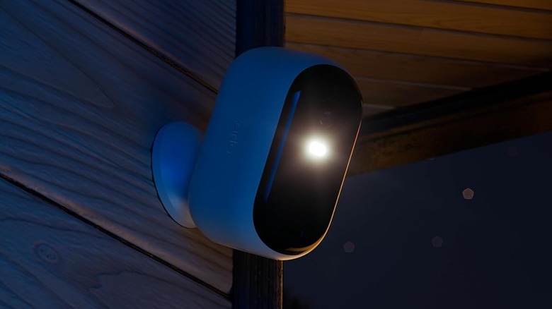 Arlo Essential camera mounted on outside wall at night