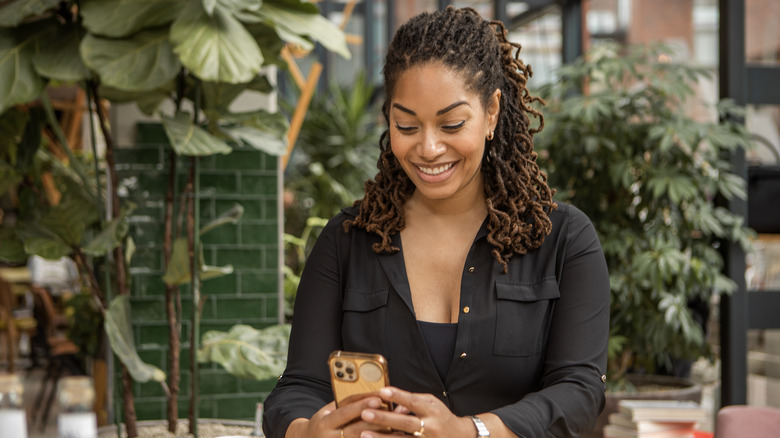 woman typing on iPhone