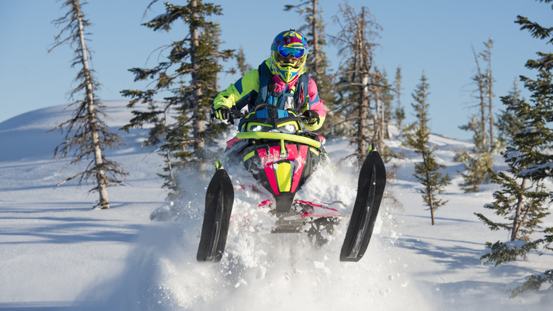 Snowmobile jumping off the snow