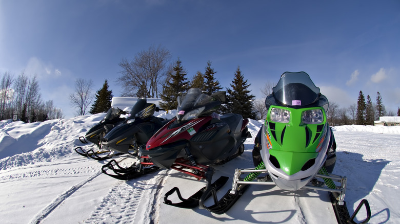 Snowmobiles parked in the snow