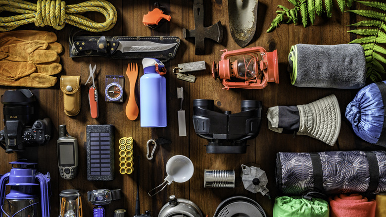 Camping and hiking gear arranged on a table