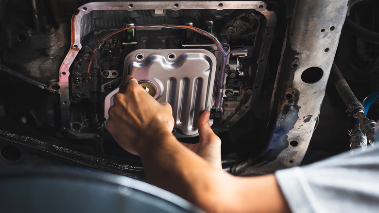 Mechanic Changing A Transmission Filter