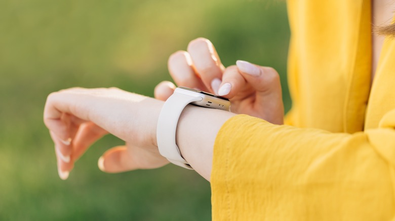 person tapping smartwatch