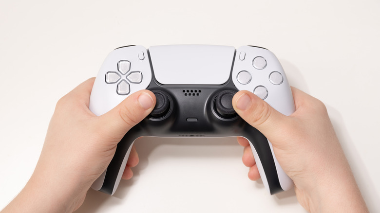 dualsense controller in hand