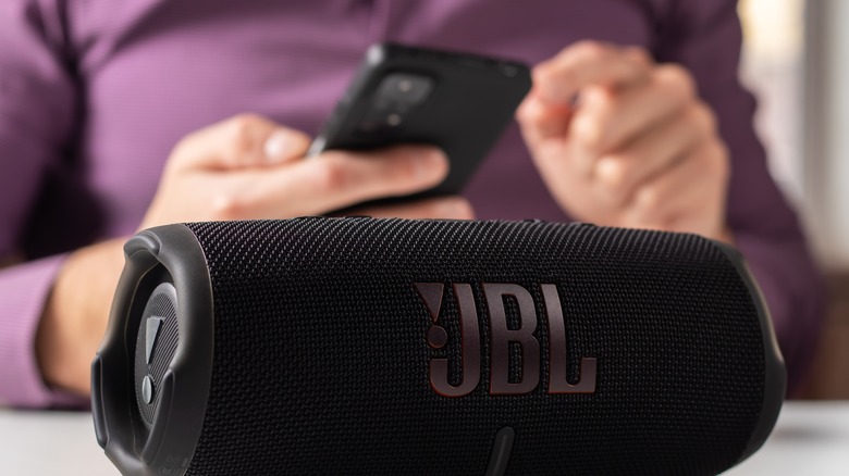 person connecting to JBL speakers