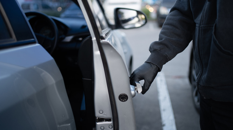 thief unlocking car door