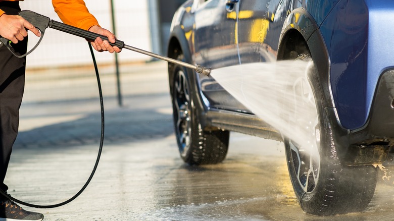 Person washes the wheels and tires