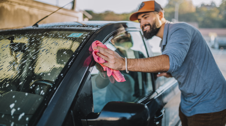 A person washing their car