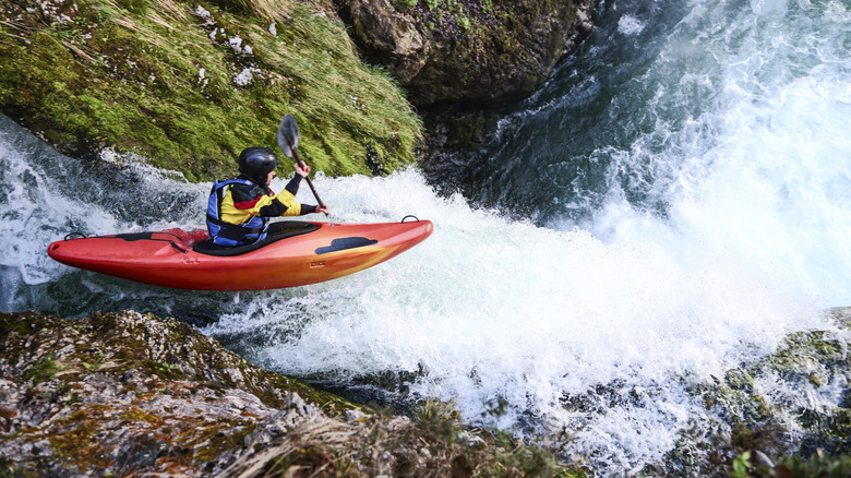 Person kayaking in rapids