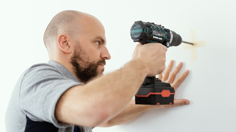 Man drilling into wall