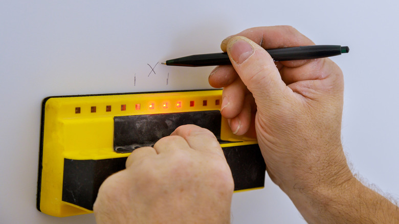 Person using stud finder