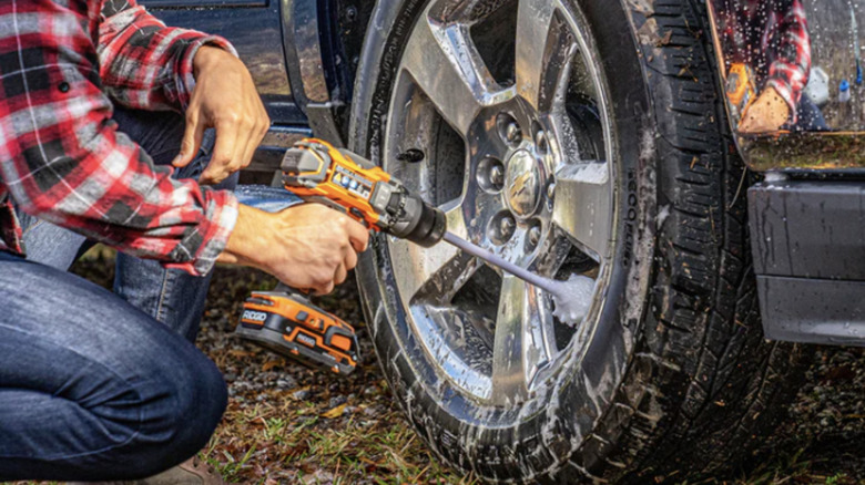 Drill scrubbing attachment to clean wheel