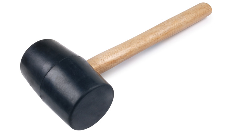 Close up of rubber mallet with wooden handle