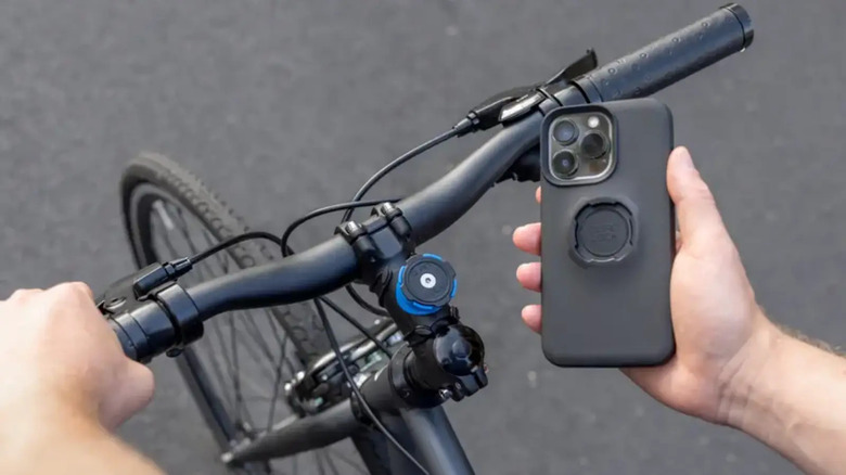 person on bike holding phone