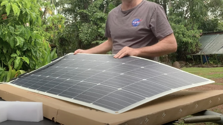 Person showing off flexible solar panel