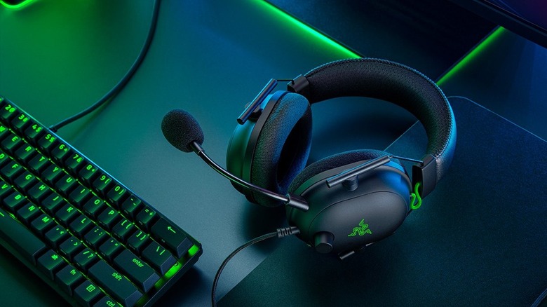 The Razer BlackShark V2 on a green neon-lit table.