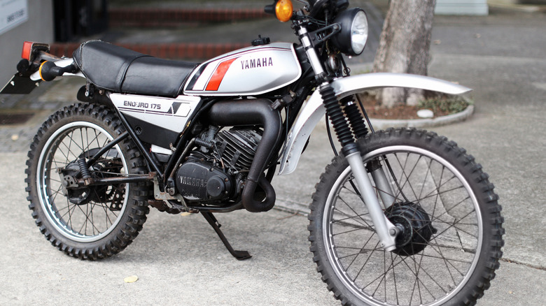 A classic '80s Yamaha bike parked on the street