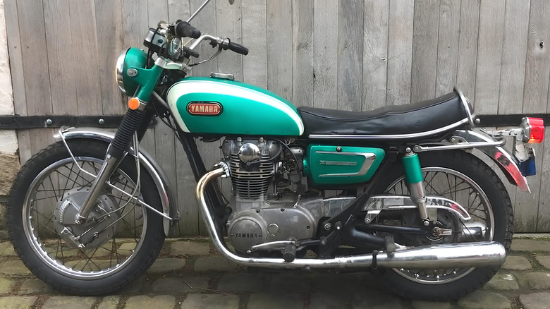 A 1970 Yamaha XS-1 motorcycle parked in front of a building