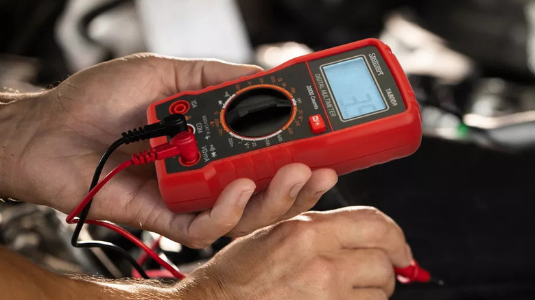 Person using multimeter